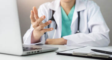 Image of doctor explaining something in a telehealth session. If you have sexual concerns in Minnesota, talk with a doctor and a Plymouth, MN sex therapist with online therapy in Minnesota.