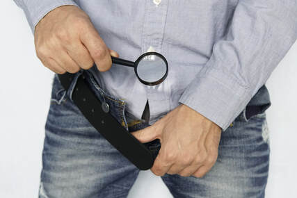 Picture of a man looking into his open jeans with a magnifying glass. Concerns about erectile dysfunction treatment, porn and masturbation, and more can be discussed in sex therapy in Plymouth, MN and couples counseling Minneapolis, MN here and via online therapy in Minnesota.