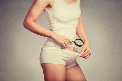 Picture of a woman looking with a magnifying glass into her pubic region. Pubic hair questions and more sexual health can be answered in sex therapy near Minneapolis, MN with a sex therapist from Plymouth, MN via online sex therapy in Minnesota here. 55447 | 55441 | 55442