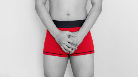 Picture of a man holding his hands over his pelvis wearing bright red underwear. Consider talking with a sex therapist in Plymouth, MN for porn addiction counseling, sex therapy, and help for out of control sexual behavior in Minnesota.