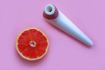 Clitoral suction toy next to a grapefruit to signify the success a toy can have on female orgasm. Get more tips and sex therapy from a Minneapolis, MN sex therapist near me and online sex therapy in Minnesota from a Plymouth, MN sex therapist here.