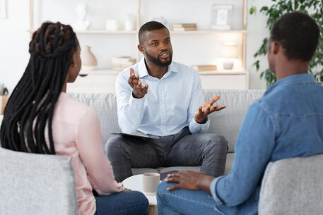 Picture of couple talking with another person on a couch in a room. Sex therapy, marriage counseling and couples therapy can be helpful in Plymouth, MN, Minneapolis, MN and beyond via online therapy in Minnesota here.