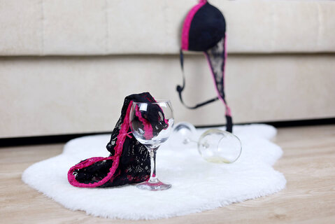 Empty wine glasses with underwear on the floor. Adults dealing with alcohol addiction, substance abuse and impacts on sexuality or sex can get treatment through sex therapy in Minnesota at Sexual Wellness Institute