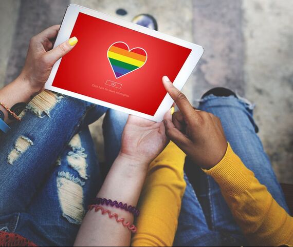 Couple using an iPad with a pride, rainbow heart on it. Learn from a lgbt therapist Plymouth, MN for inclusive and LGBTQ friendly sex therapy in Minnesota. Online therapy in Minnesota can help you!