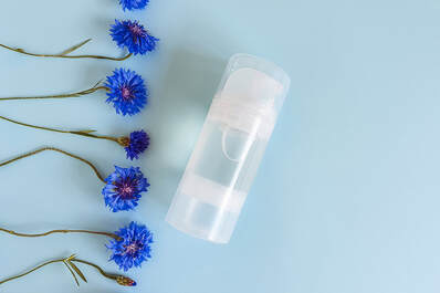 Personal lubricant on a blue background with flowers. Lube is gaining in popularity lately and a Plymouth, MN sex and relationship therapist can help. Read on for help in Plymouth, MN 55369 | 55361 | 55391