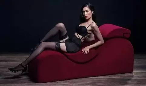 Picture of a woman sitting on a reclining chaise for sex furniture and how to build a sex room. Talk with a sex therapist near Minneapolis, MN for LGBTQ+ friendly sex therapy for men and poly relationships and more. Consider online therapy in Minnesota for sex therapy near Plymouth, MN and beyond here!