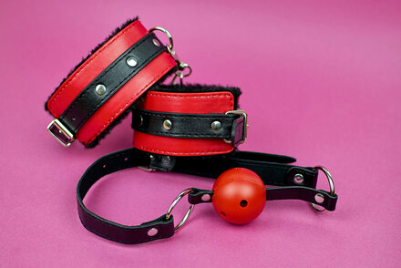 Picture of handcuffs and a ball gag for BDSM. Sex therapy can help if you are curious about BDSM or want to discuss concerns with a professional sex therapist in Plymouth, MN. Get help via online sex therapy in Minnesota here too!