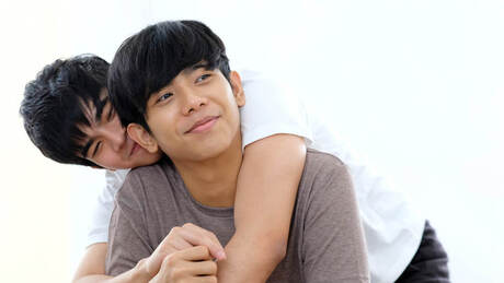 Asian male couple embracing. Sex addiction therapy and counseling can be addressed with a Twin Cities sex therapist. Meet with a sex therapist in Plymouth, MN to discuss sexual performance anxiety here. 55447 | 55441 | 55442