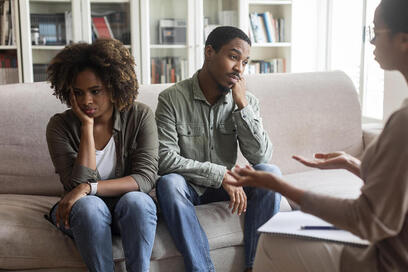 Black couple in marriage counseling looking upset and distraught. Gottman Method Couple Therapy in Plymouth, MN can help twin cities couples and via online therapy in Minnesota here. 55447 | 55441 | 55442